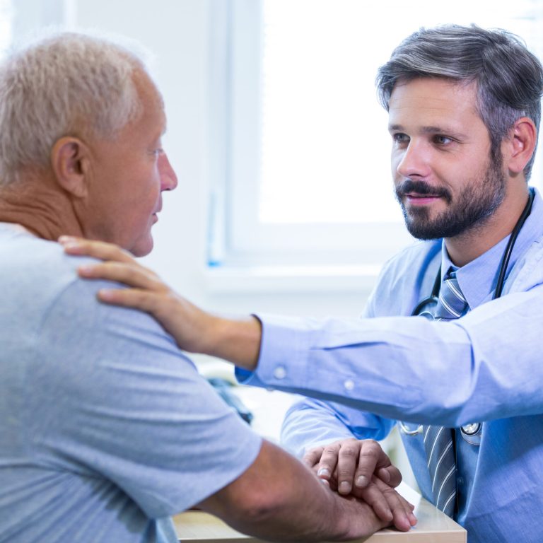 Male doctor examining a patient at the hospital